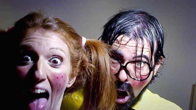 A weird salesman and his female assistant doing a peek-a-boo (surprising the viewer). Funny bizarre foolish characters.
