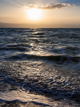 sunset and surf at Dead Sea in winter dusk
