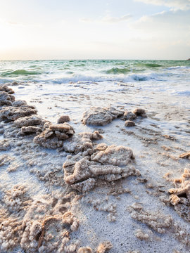 crystals of salt on coast of Dead Sea in evening