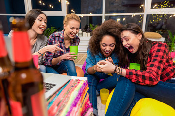 Fototapeta premium Surprising females watching at mobile