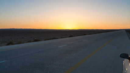 Fototapeta na wymiar sunset over Desert Highway (Road 15) in Jordan