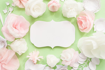 Vintage frame with color paper flower on green background.