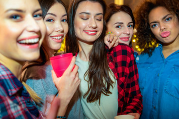 Happy young women mugging in room