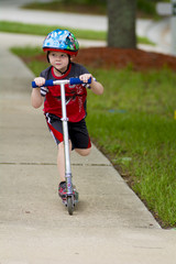 young boy on scooter 