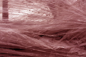 Red color plastic wrap surface.