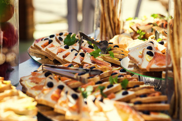 Naklejka na ściany i meble buffet table, Canape with salmon, sandwiches, snacks, holiday table, sliced, celebration,fourchette, catering, table setting, restaurant
