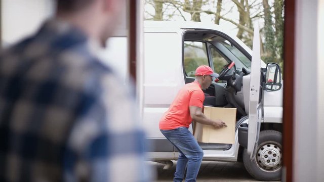  Clumsy delivery driver almost drops parcel before delivering to customer
