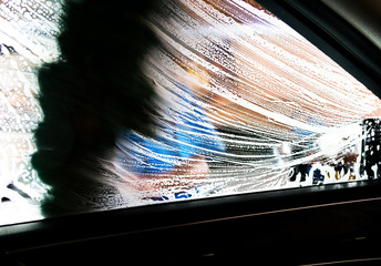 Car wash with flowing water and foam.