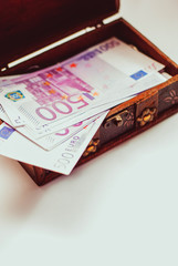 Euro banknotes in a vintage wooden casket