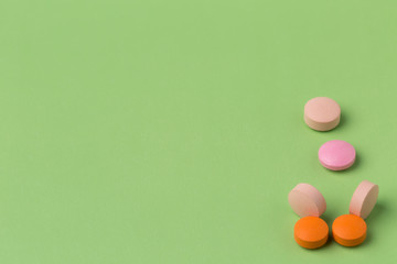 Various round pills on color background