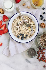 Ingredients for preparing of  overnight oats with fresh berries and various of super foods topping. Clean eating and super food concept.