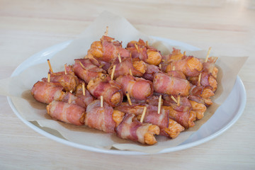 Deep fried sausages rolled in bacon