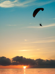 paragliding on the see at the sunset