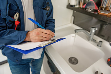 Male person keeping blue clipboard