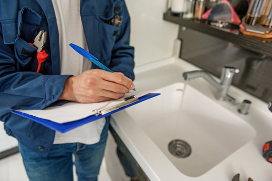 Male person keeping blue clipboard