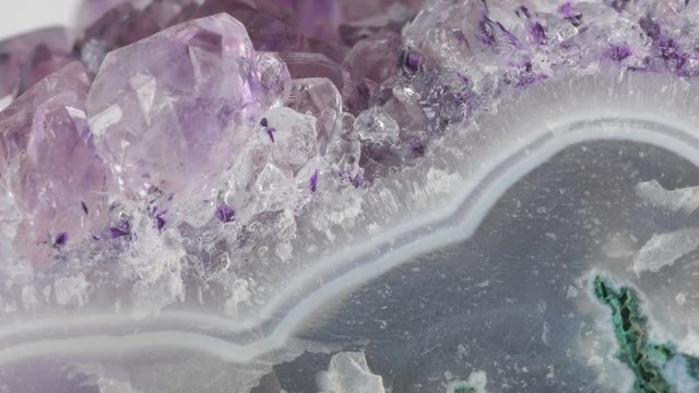Amethyst geode crystals on gemstone. Extreme close up macro shot with sliding.
