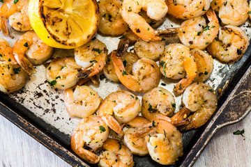 Shrimp On Metal Pan With Grilled Lemon Wedge
