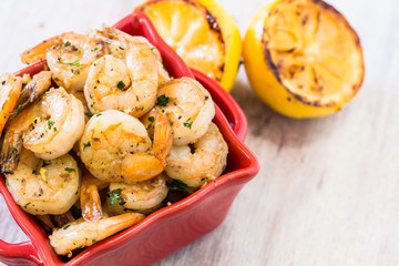 Shrimp Appetizer in Red Bowl With Lemon Halves