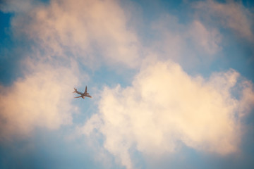 Fototapeta na wymiar Airplane in a sunset sky