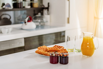 Tasty pastry with jam and healthy drink on desk