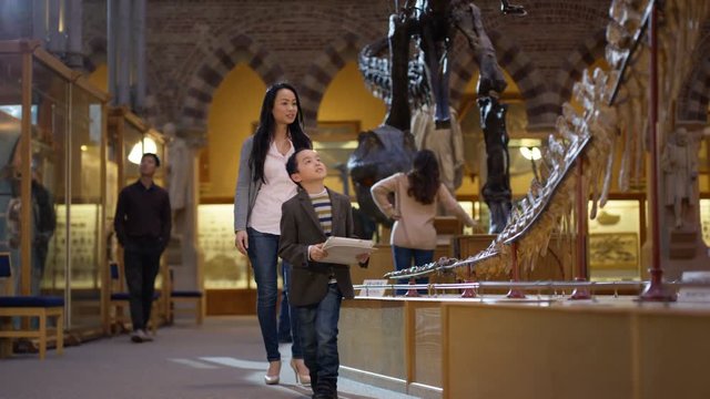  Mother & son in natural history museum pose to take a selfie with tablet