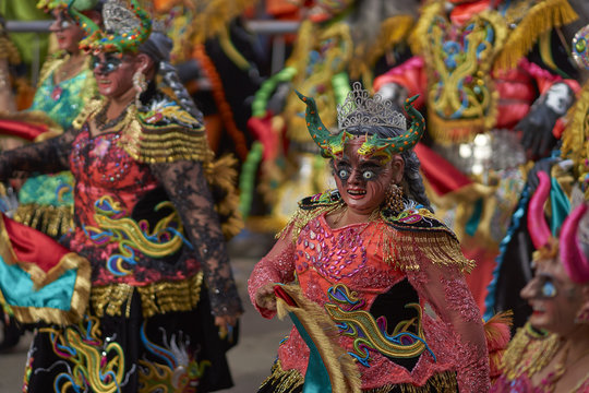 Masked Diablada dancers in ornate costumes parade through the mining city of Oruro on the Altiplano of Bolivia during the annual carnival.