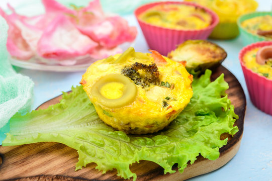 Omelette with colored pasta, mushrooms, vegetables and herbs, cooked in the form of mafins.  Breakfast.