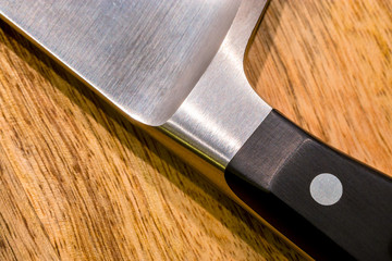 Kitchen knife on wooden board close-up