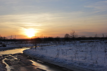 winter road is in a rural location sunset