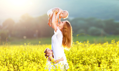 Happy family mother and childrn hugging  nature in summer