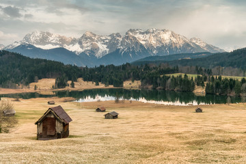 Alpine Panorama of a lake called geroldsee with huts in front and mountains in the background