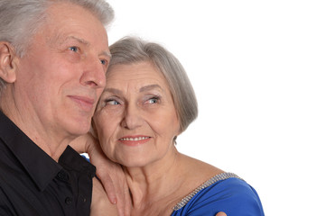 Happy old couple embracing on a white background
