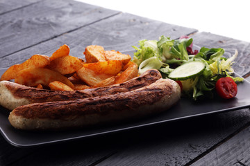 grilled sausages and potatoes and salad