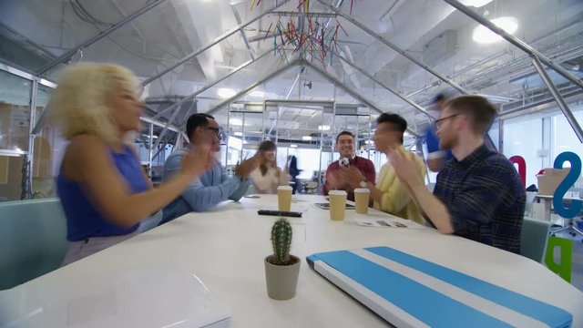  Time lapse of busy creative business team working hard in trendy office