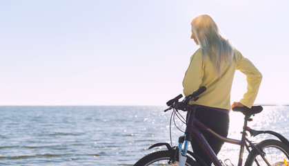 Obraz premium A girl on a bicycle by the sea