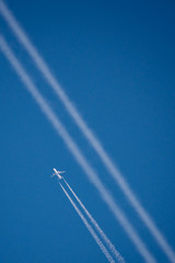 Single jet with visible smoke lines next to path after another one