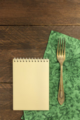 Vintage fork and notepad for copyspace, overhead shot