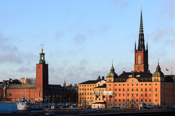Fototapeta premium Cityscape view of Stockholm, Sweden with City hall to left and The Riddarholmen Church to the right