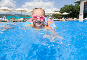 little girl playing  in pool