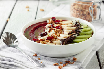 Cherry smoothie bowl with fruits and granola