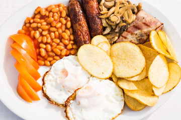 Full English Breakfast including sausages, tomatoes and mushrooms, egg, bacon, baked beans and chips.