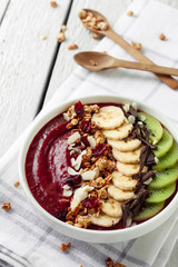 Cherry smoothie bowl with fruits and granola