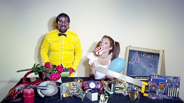 A weird salesman throwing candies in the air, creating a rain of sweeties, together with a female assistant. Funny comedy foolish characters.
