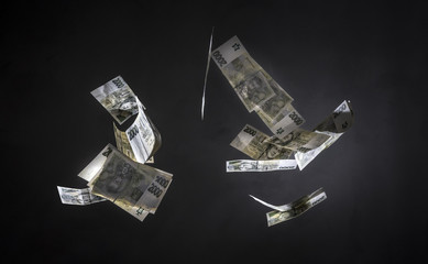 Czech money (2000 crowns banknotes) freeze in motion on black background