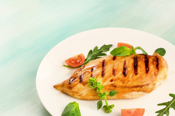 Grilled chicken fillet with cherry tomatoes and salad leaves