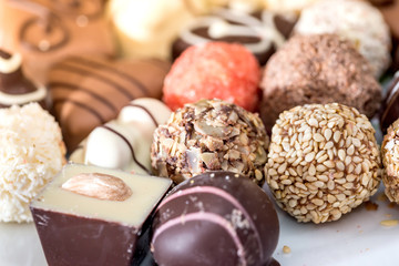Top view on different of delicious chocolate candies, white, dark, and milk chocolate.