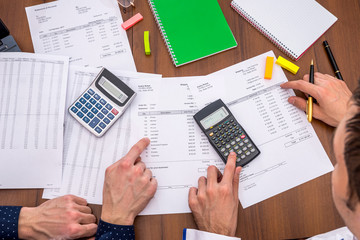 The team analyzes the business expenses of the annual budget.