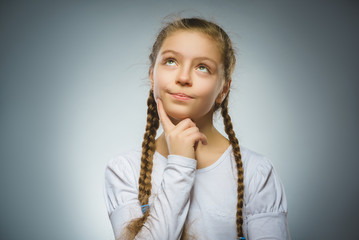 Closeup Thoughtful girl with Hand at head isolated on Gray