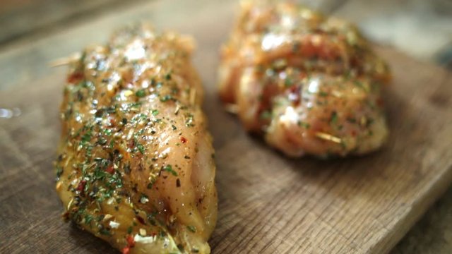 Spicy chicken breast with parsley and garlic on wooden board