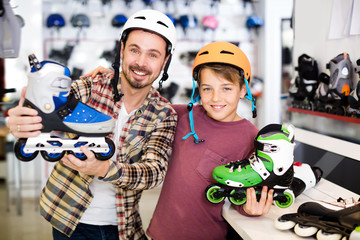 Happy father and son boasting roller-skates